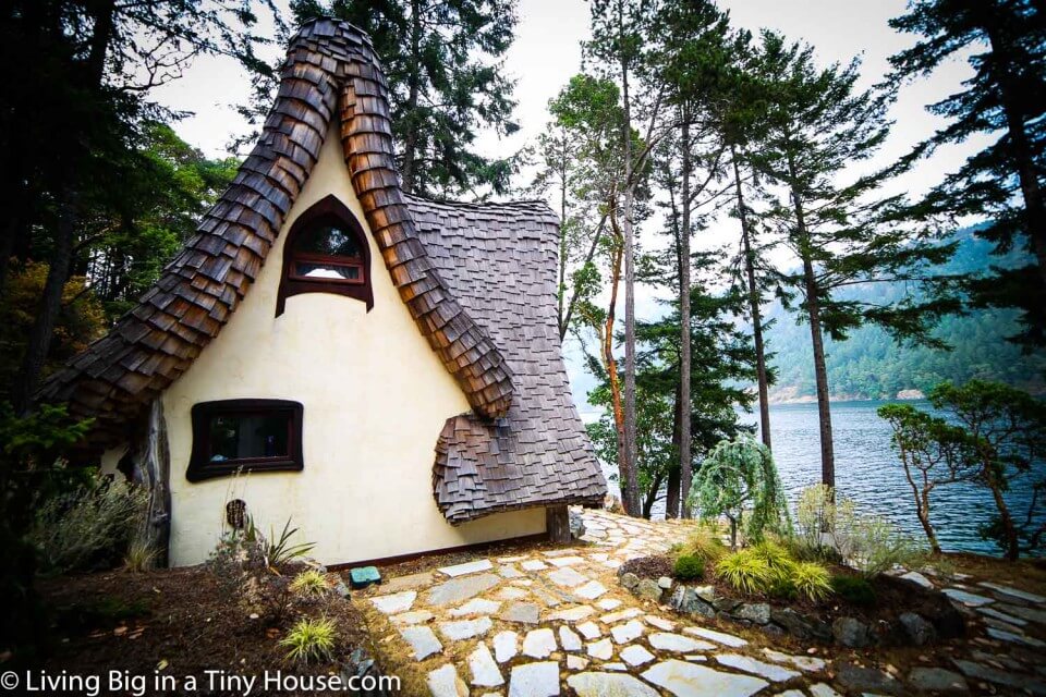 One image of the tiny home by the sea from the side.